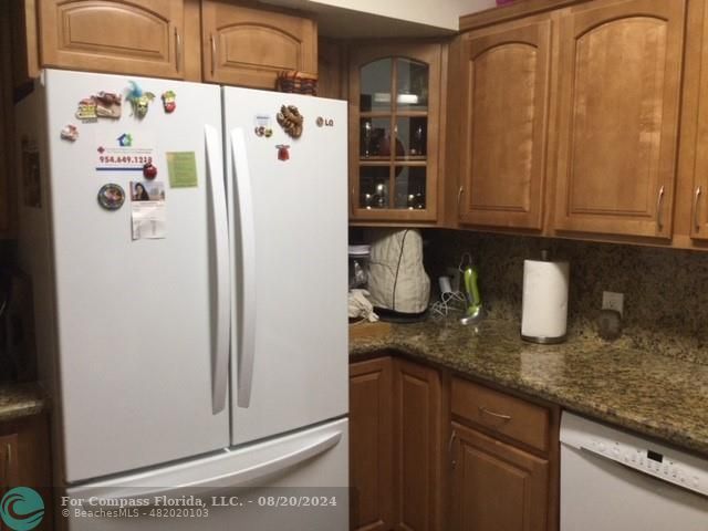 a white refrigerator freezer sitting inside of a kitchen