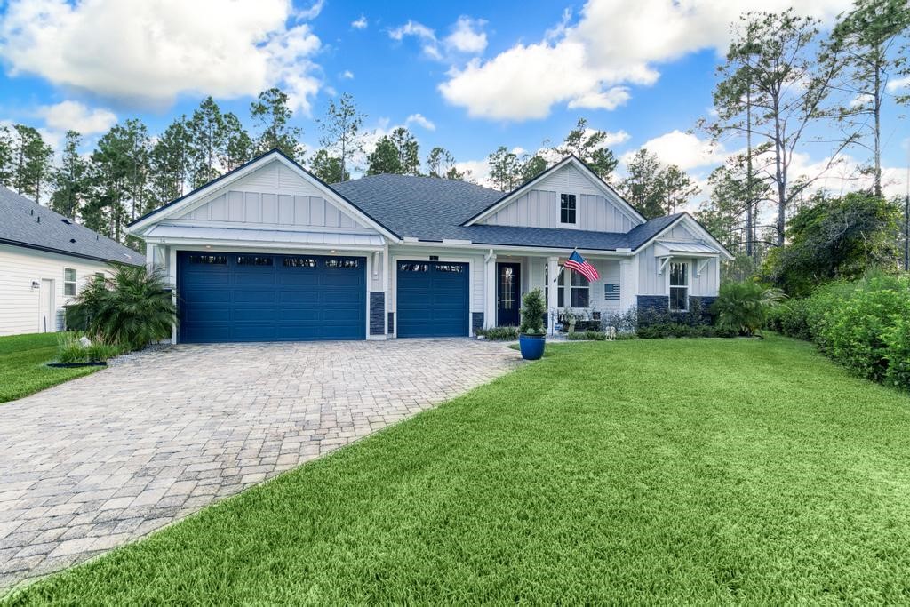 a front view of a house with a garden and yard