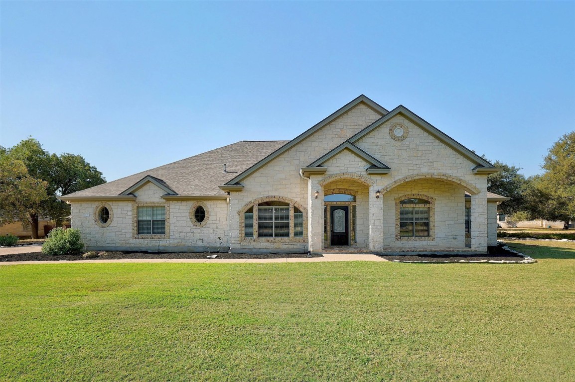 a front view of house with yard and green space