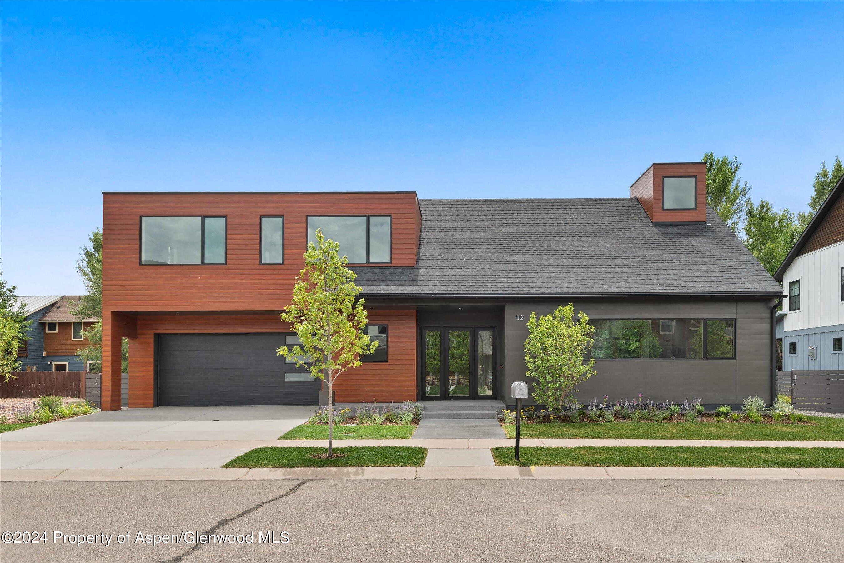 a house that has a tree in front of it