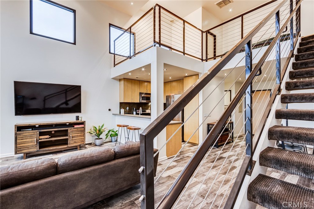 a livingroom with furniture stairs and a flat screen tv