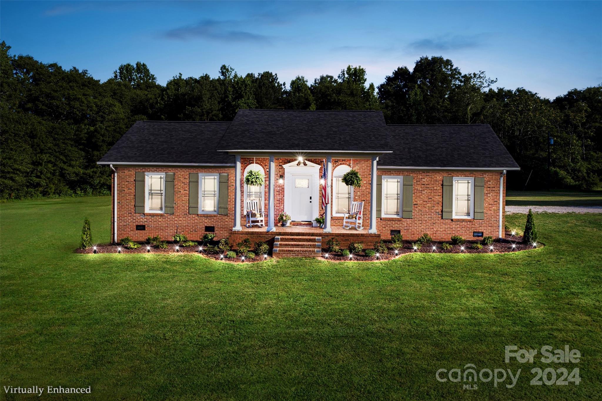 a view of a house with backyard and sitting area