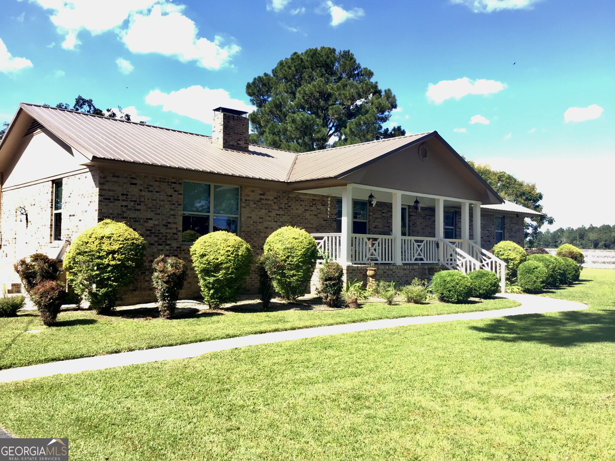 a front view of a house with garden