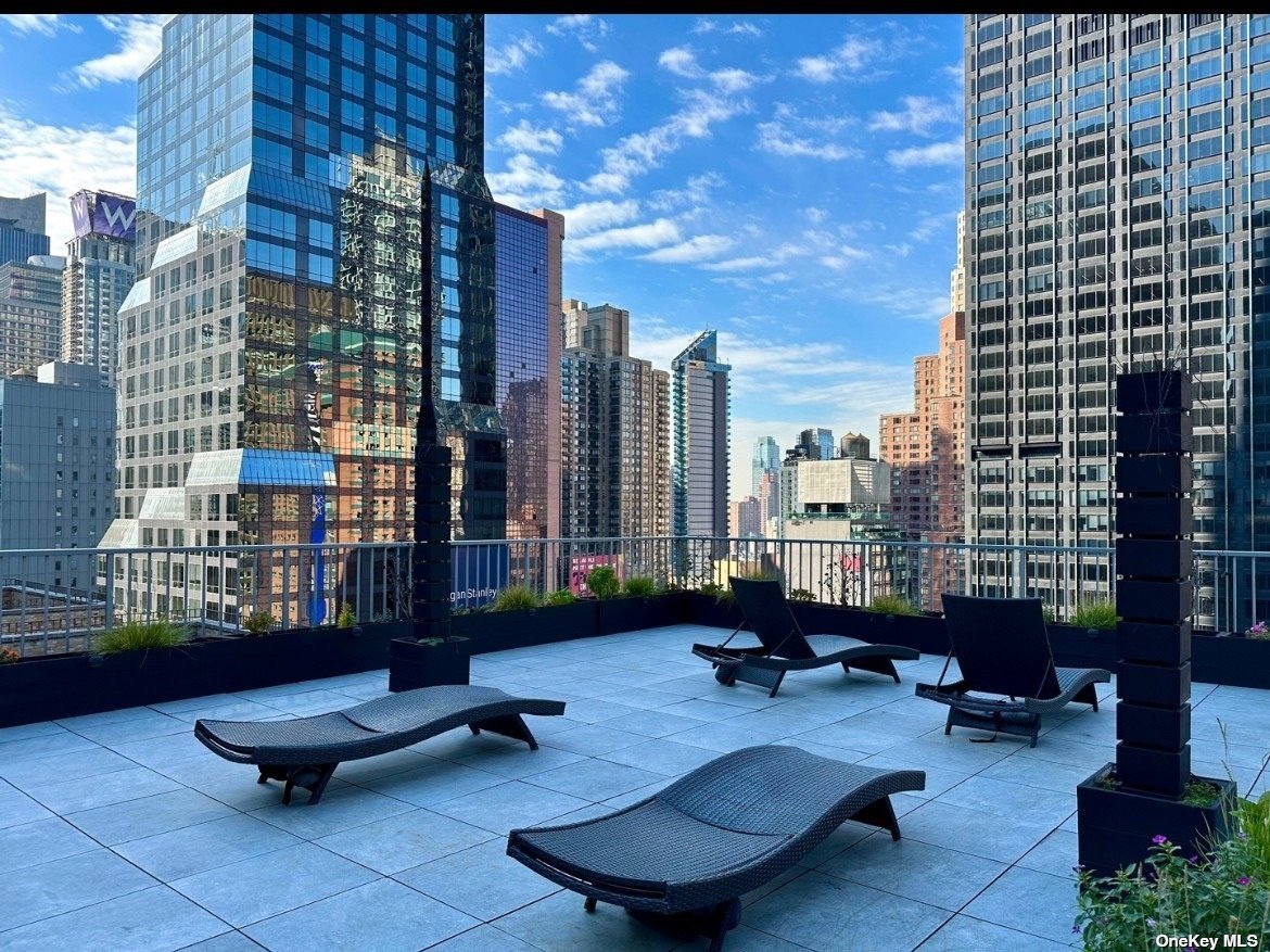 a building outdoor space with patio furniture and potted plants