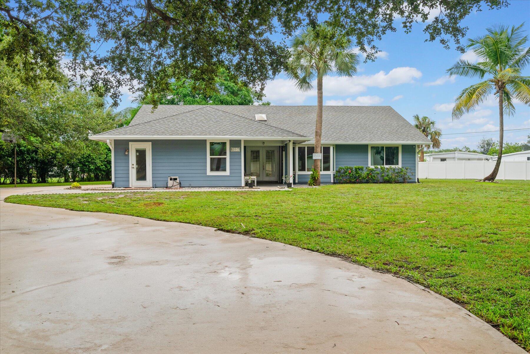 a front view of house with yard and green space