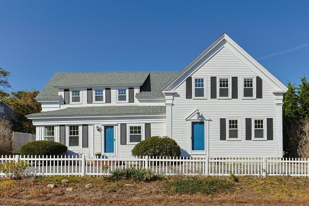 a front view of a house with iron fence