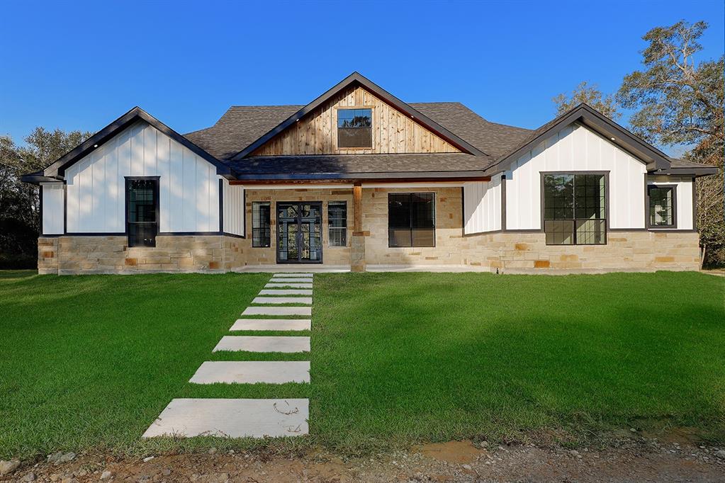 a front view of house with yard and green space