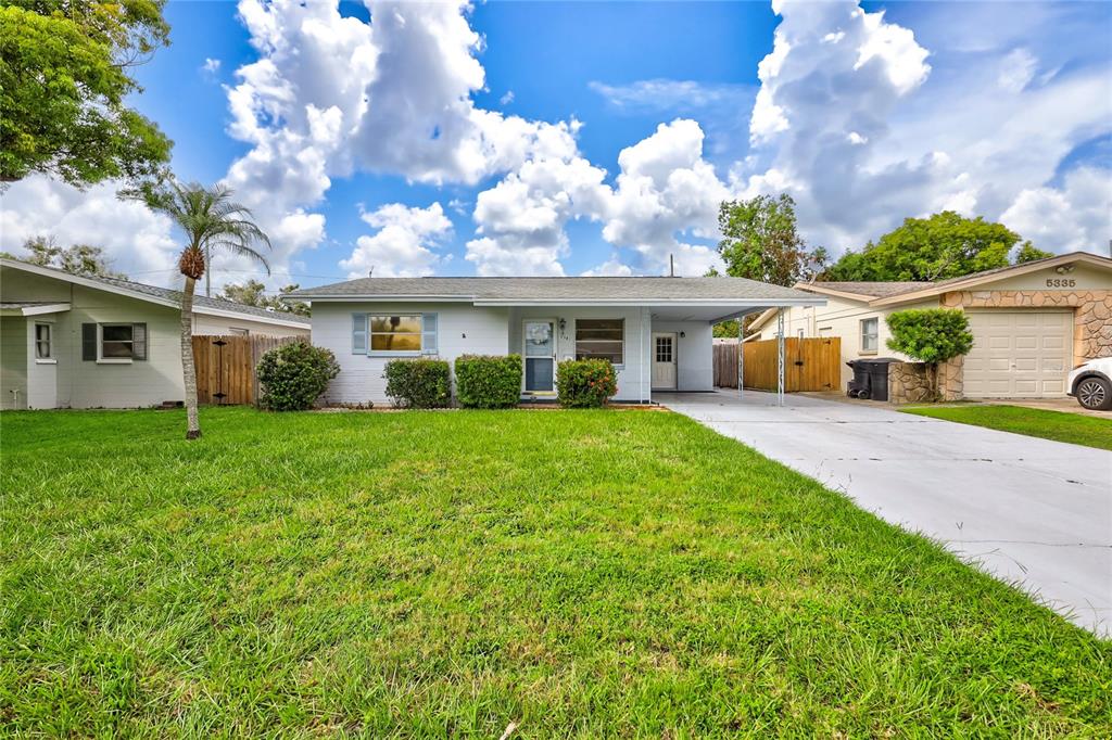 a view of house that has a yard