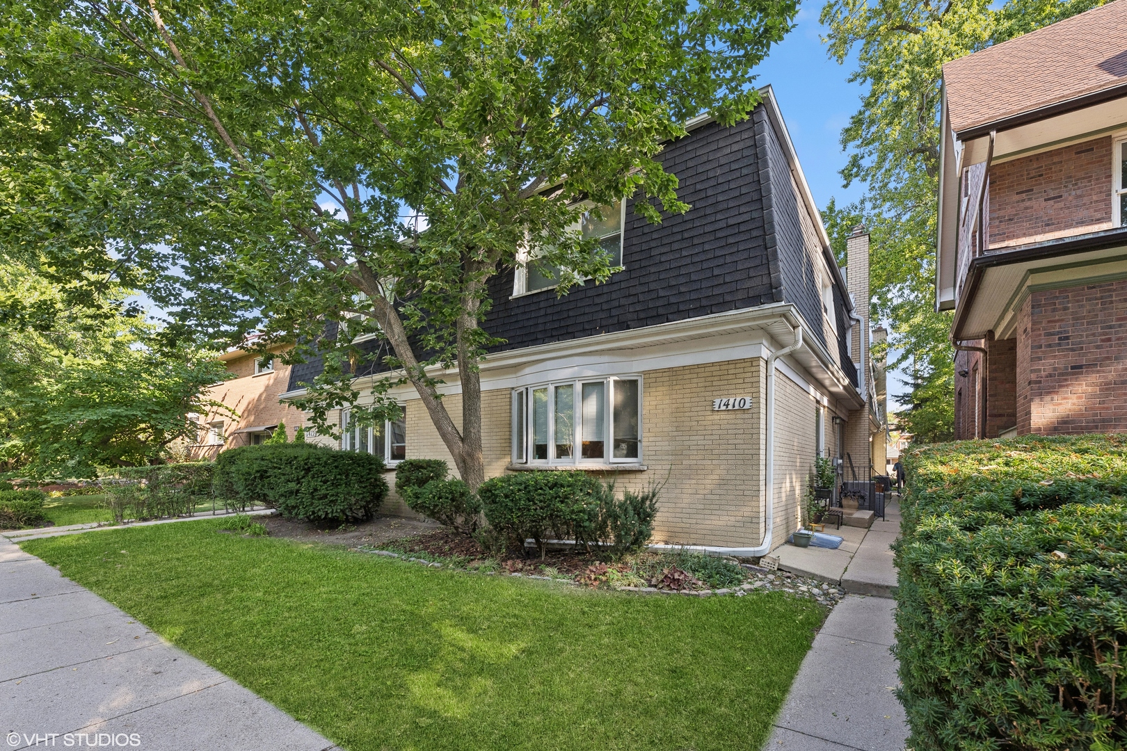 a front view of house with yard and green space