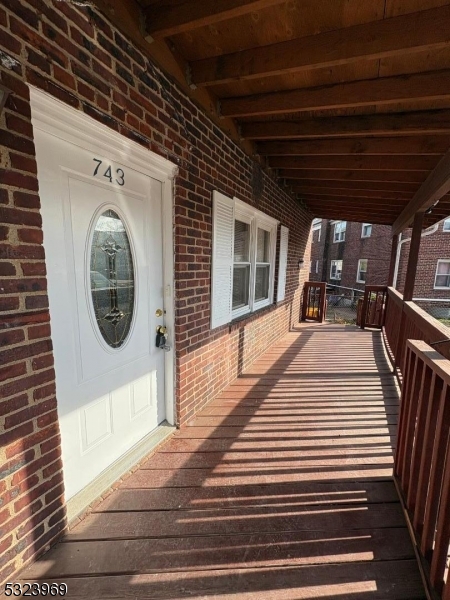 a view of a porch with wooden floor