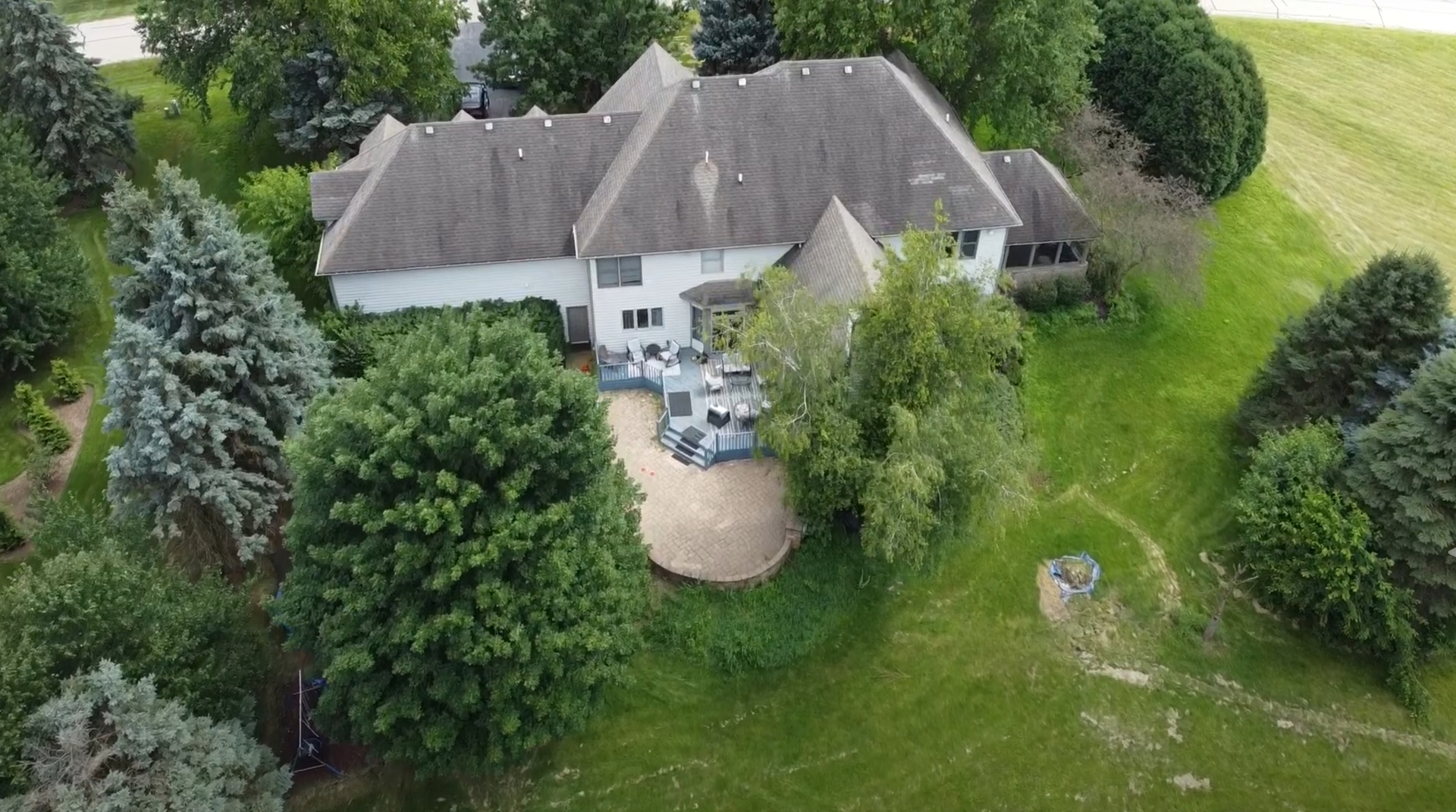 an aerial view of a house with garden space and street view