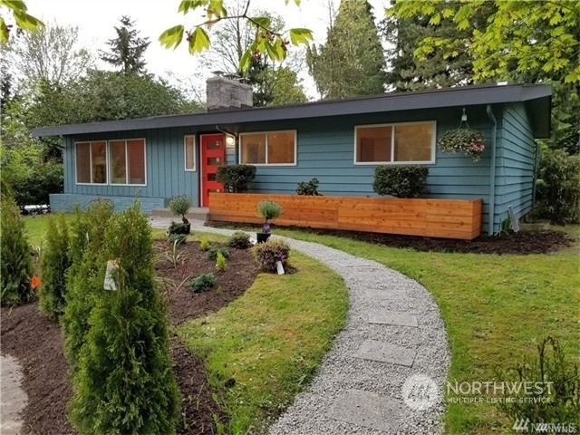 a front view of a house with a garden