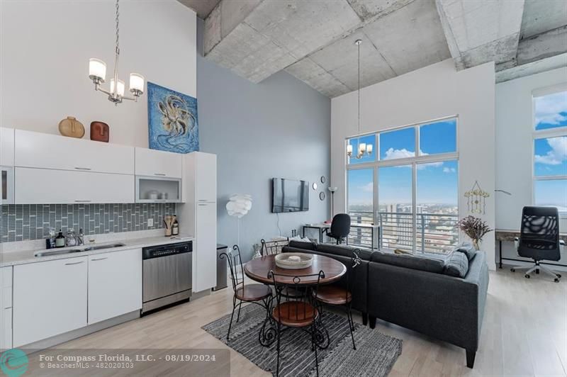 a living room with furniture and view kitchen