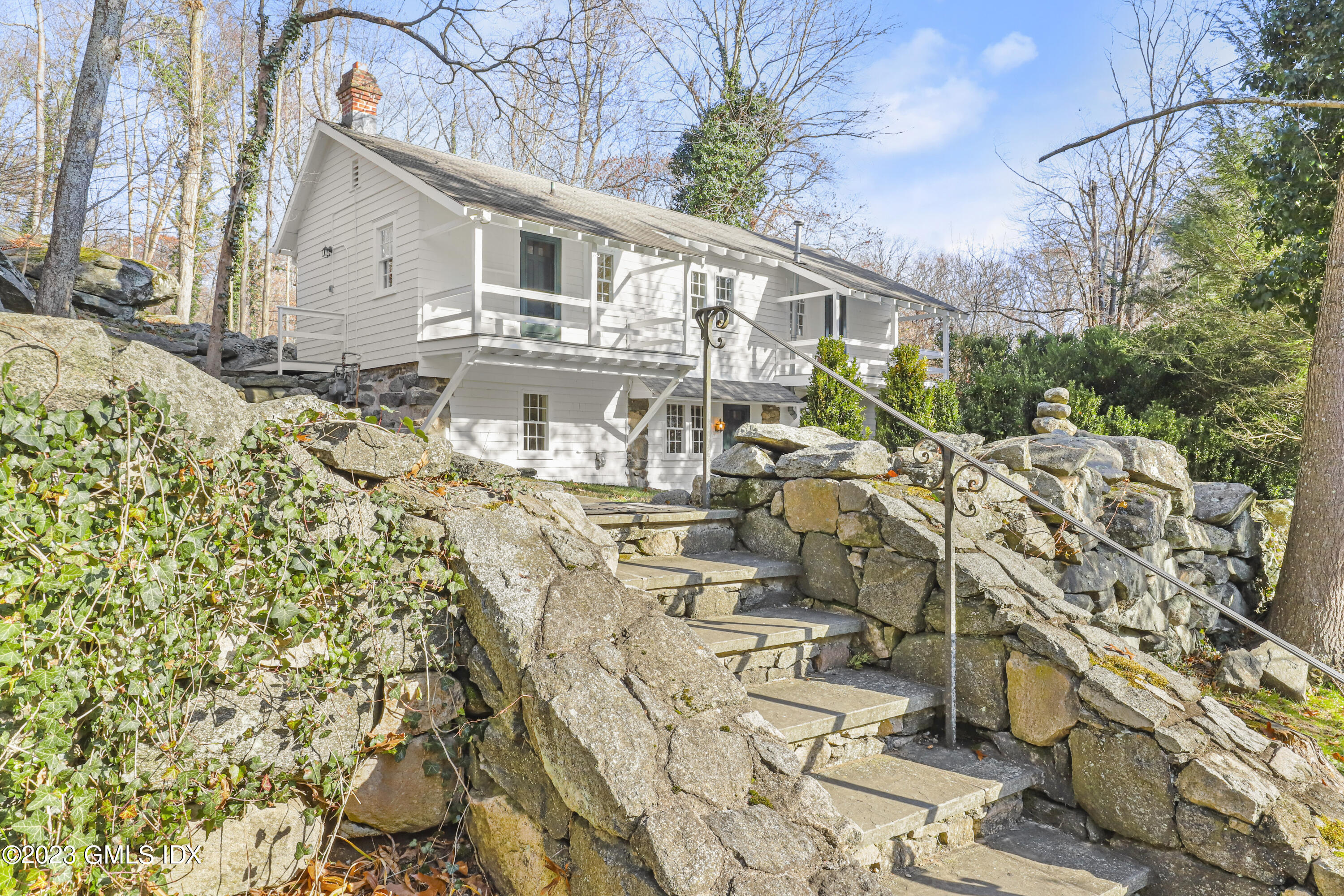 a view of a house with wooden fence