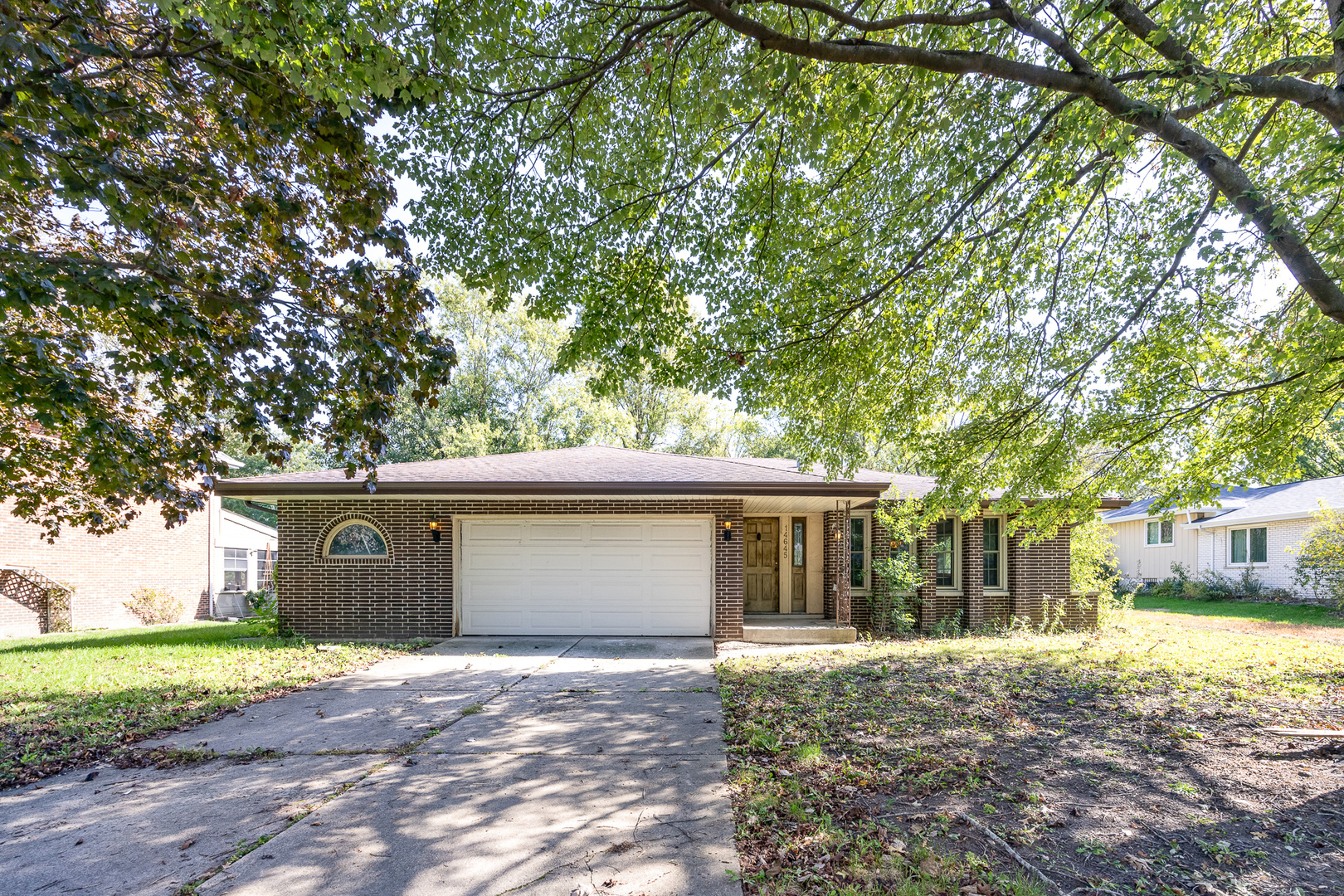 a view of a house with a yard and tree