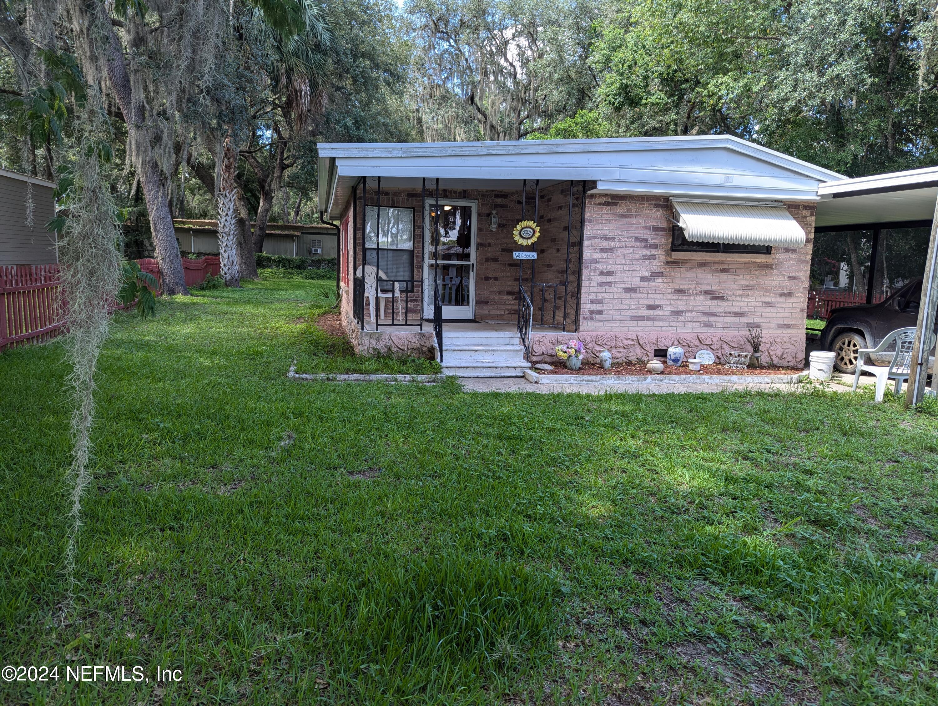 a view of a house with a yard and sitting area