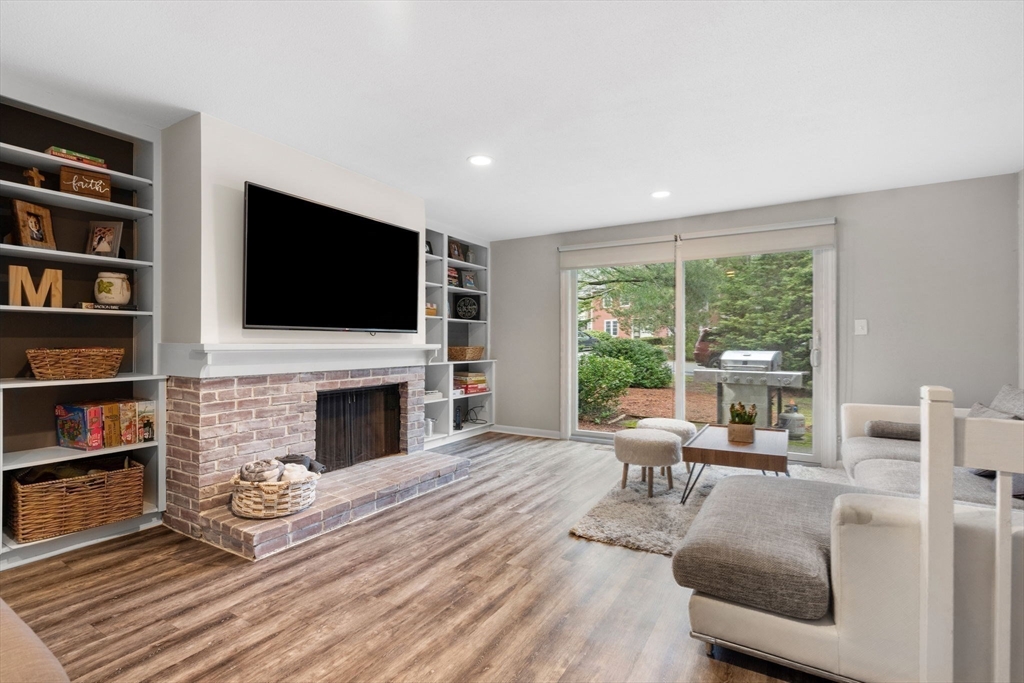 a living room with fireplace furniture and a flat screen tv