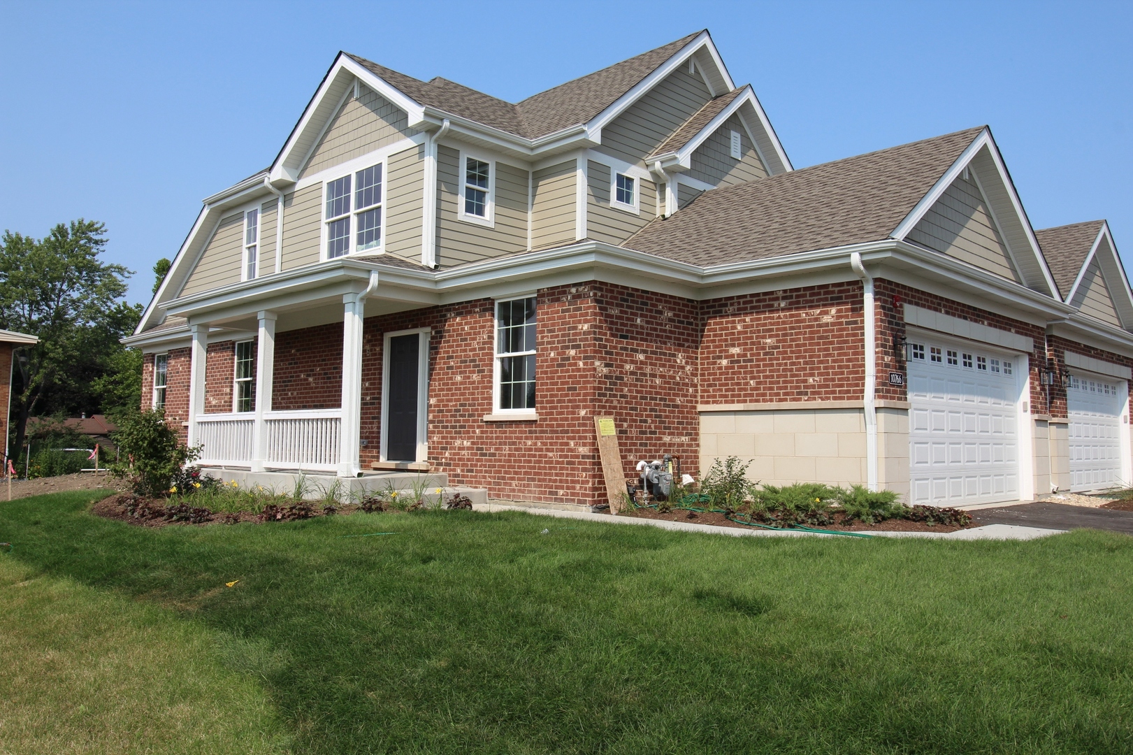 a front view of a house with a garden and yard