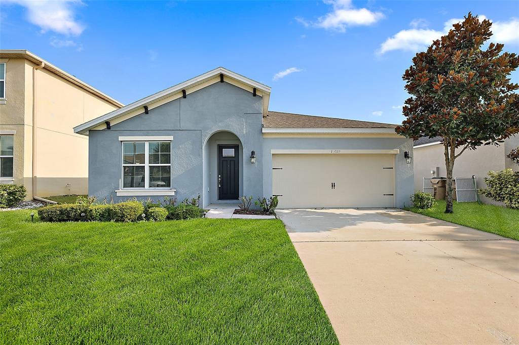 a front view of a house with a yard and garage