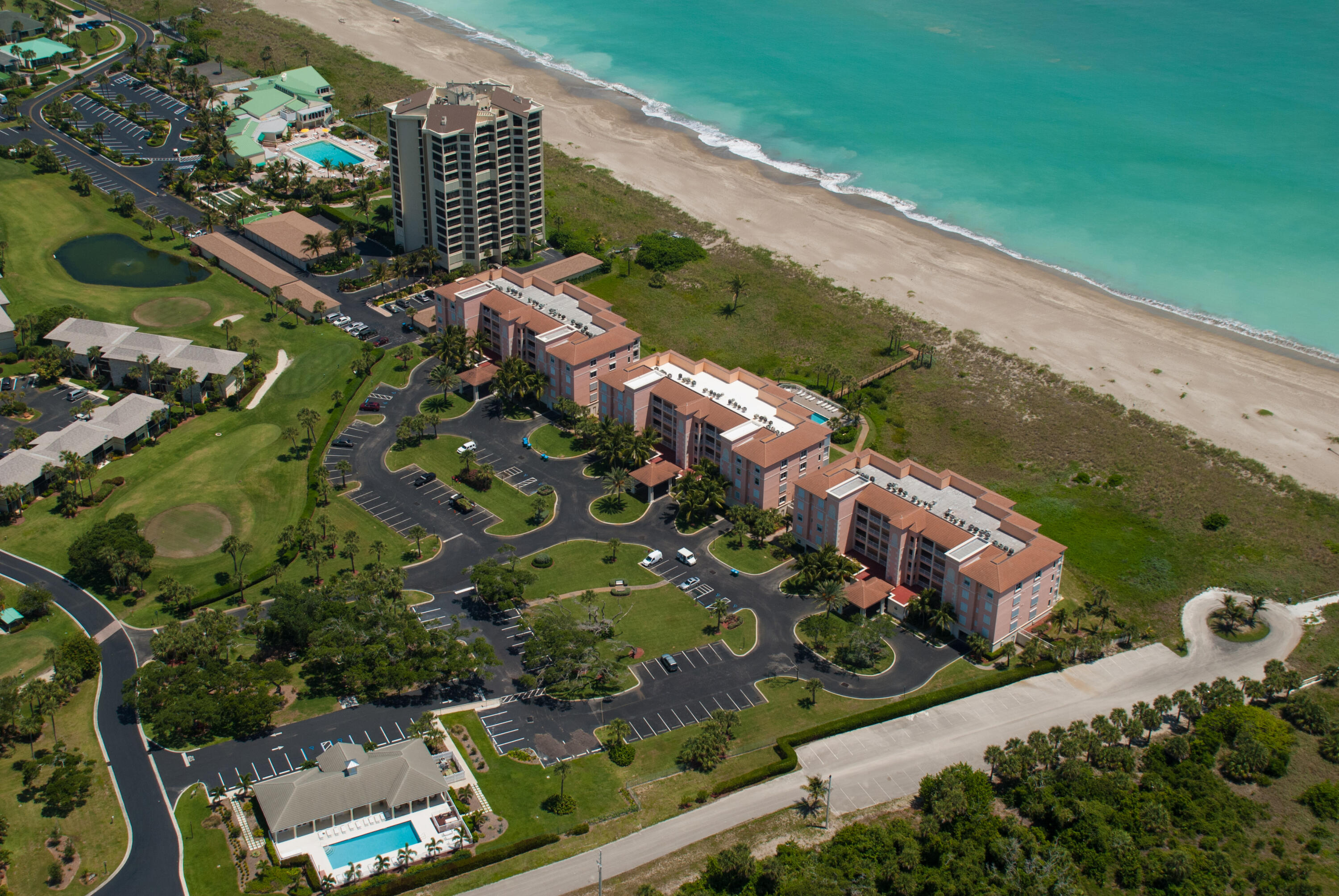 an aerial view of a house a yard and mountain view in back