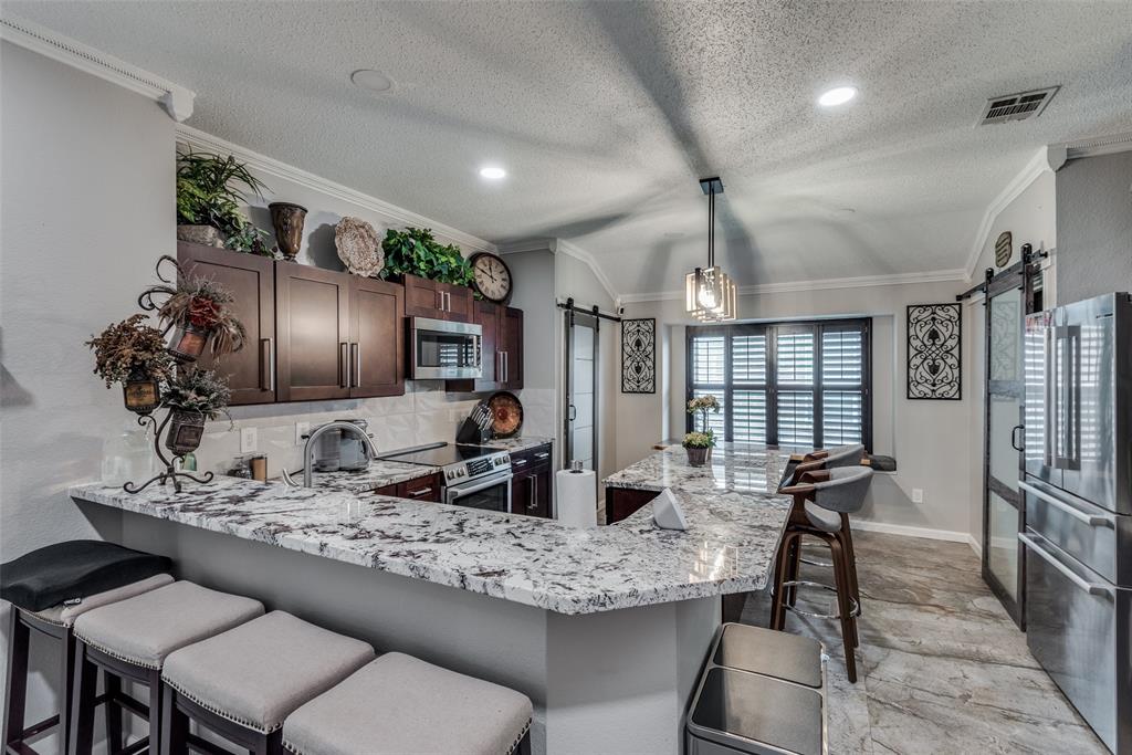 a kitchen with granite countertop lots of counter top space and stainless steel appliances