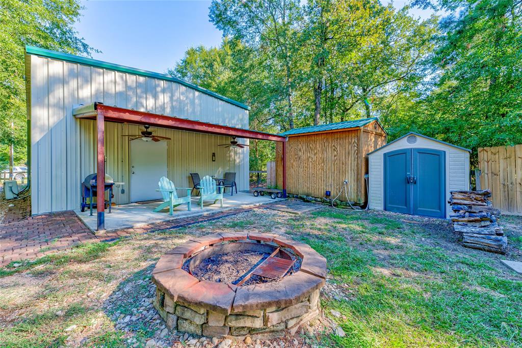 a backyard of a house with barbeque oven table and chairs