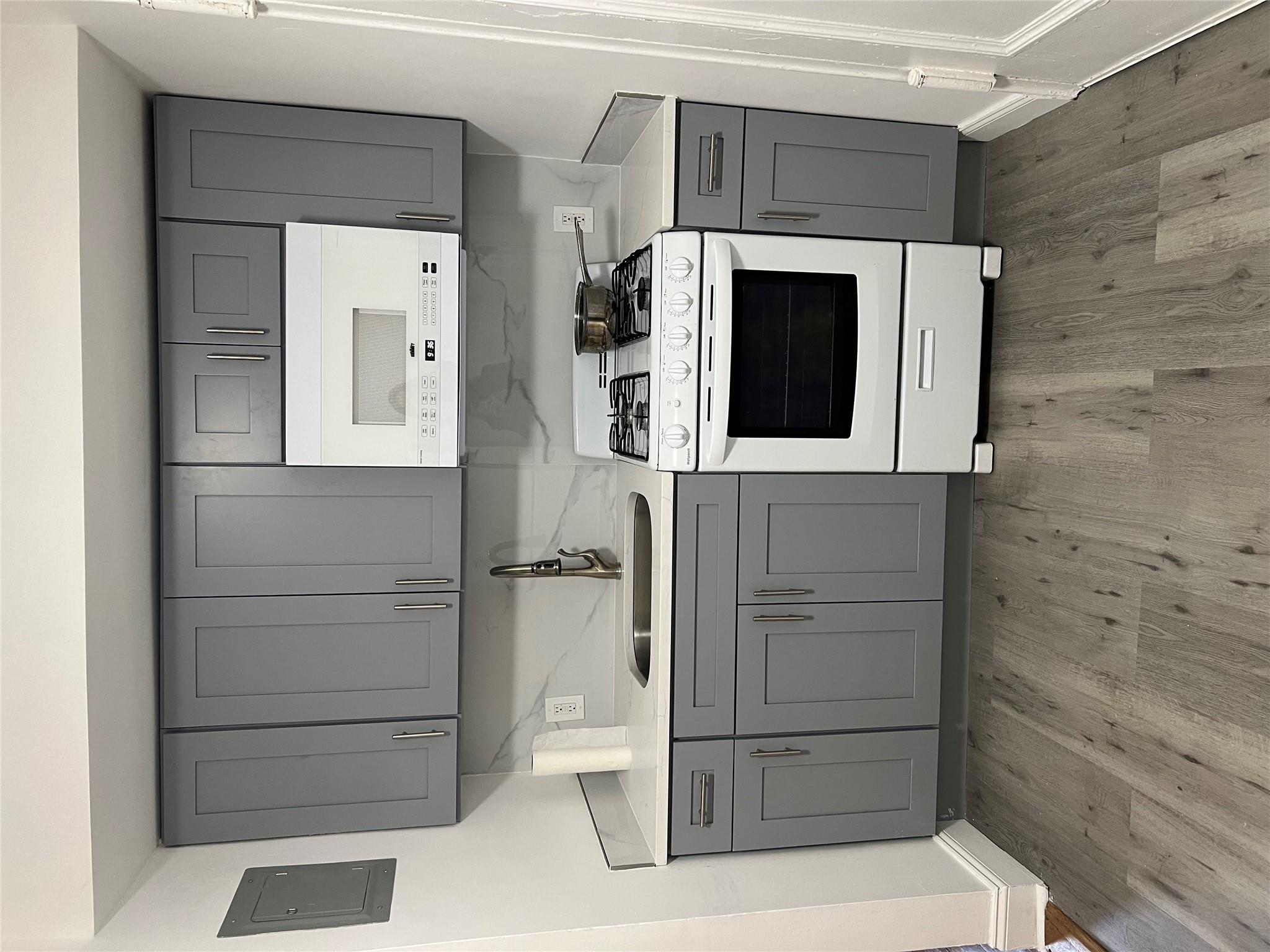 a kitchen with a sink and a stove top oven