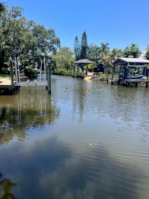 a view of a lake with boats and trees in the background