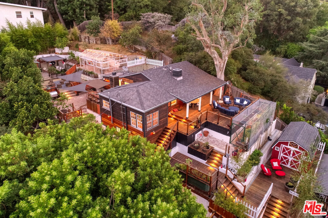 an aerial view of a house with balcony and trees