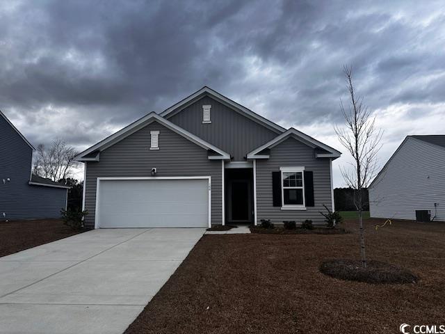 View of front of house featuring a garage and cent