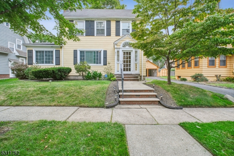 a front view of a house with a yard