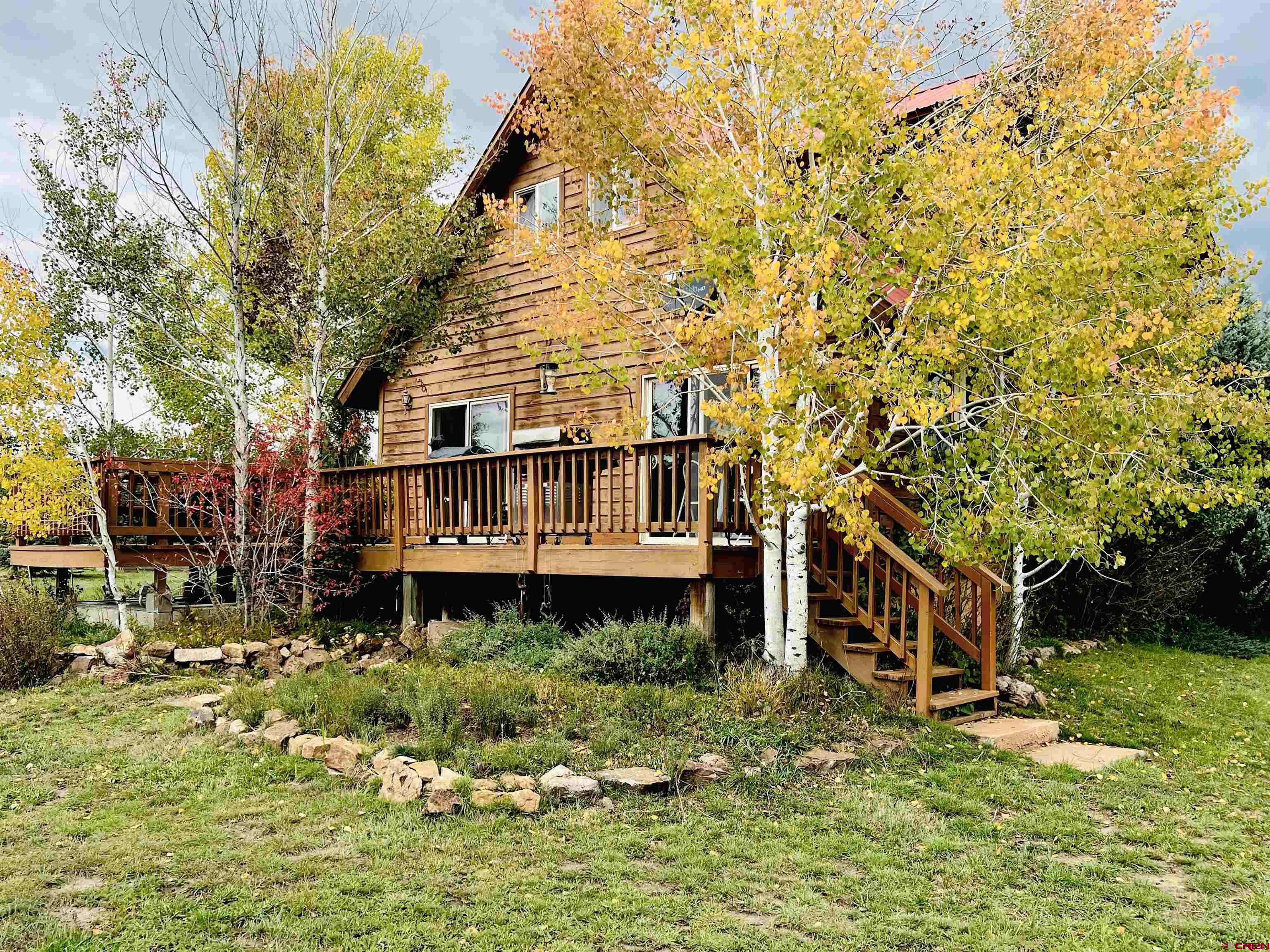 a backyard of a house with yard basket ball court and outdoor seating