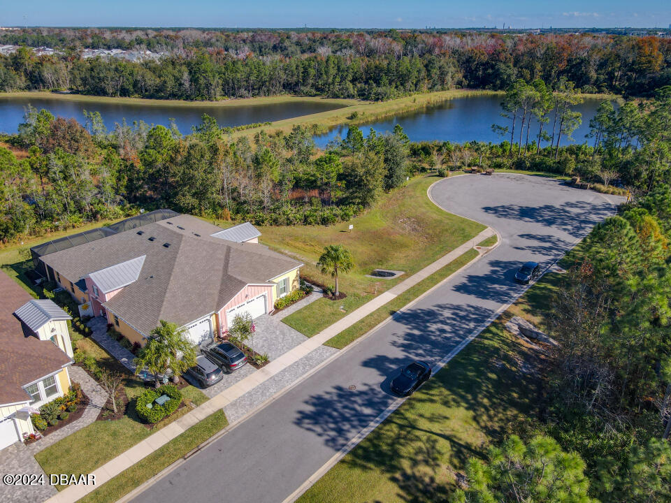 an aerial view of a house with a lake view