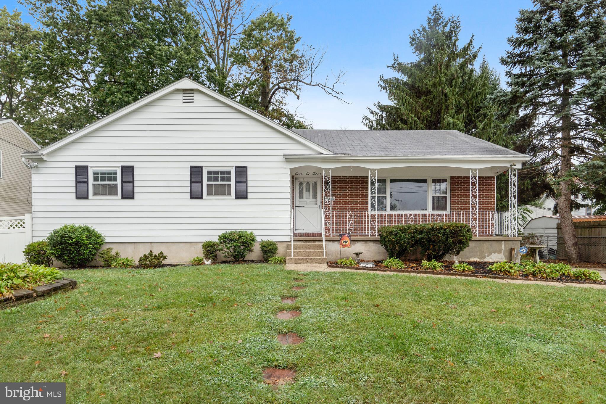 a front view of a house with yard and green space