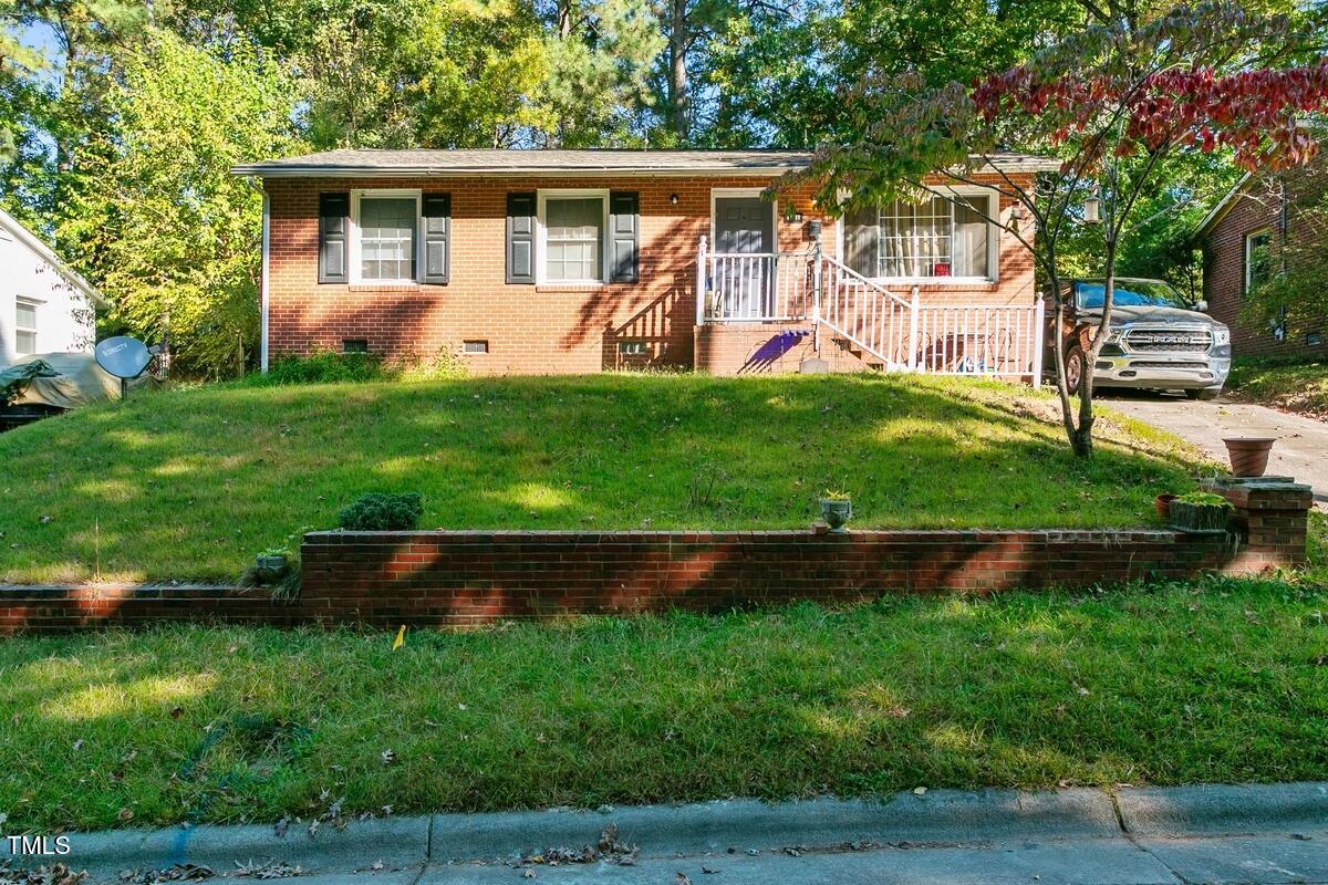 a front view of house with yard and outdoor seating