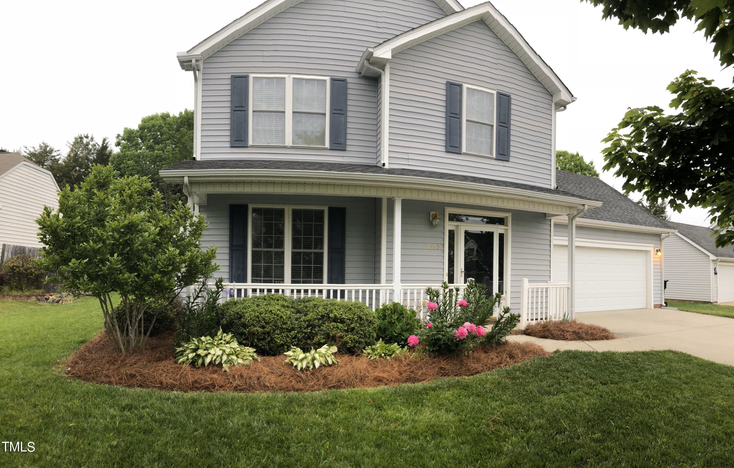 a front view of a house with a yard and porch