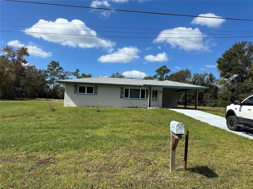 a view of a house with a yard