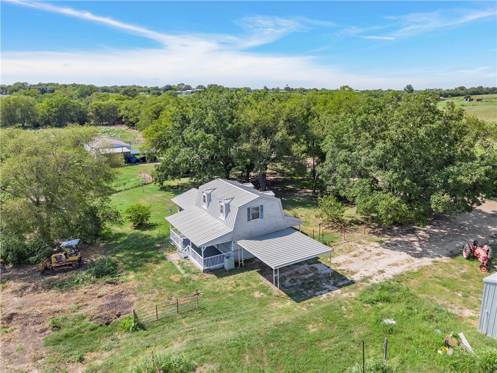 an aerial view of a house with yard