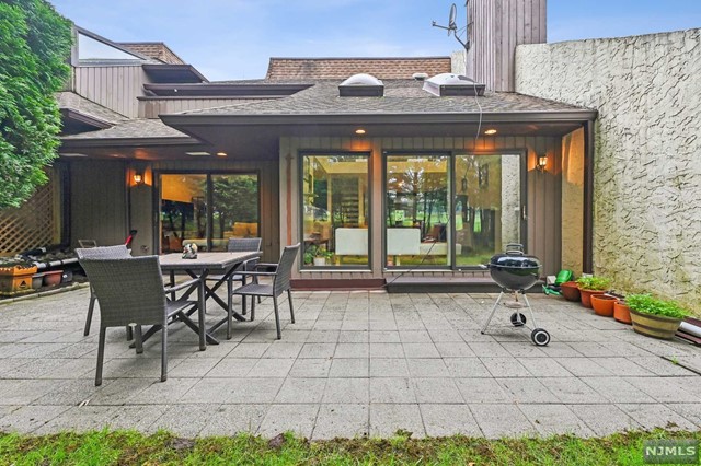 a backyard of a house with a table and chairs