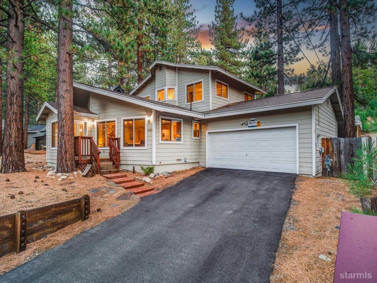 Exterior shot of the residence. Surrounded by beautiful pine trees. 2 car attached garage.