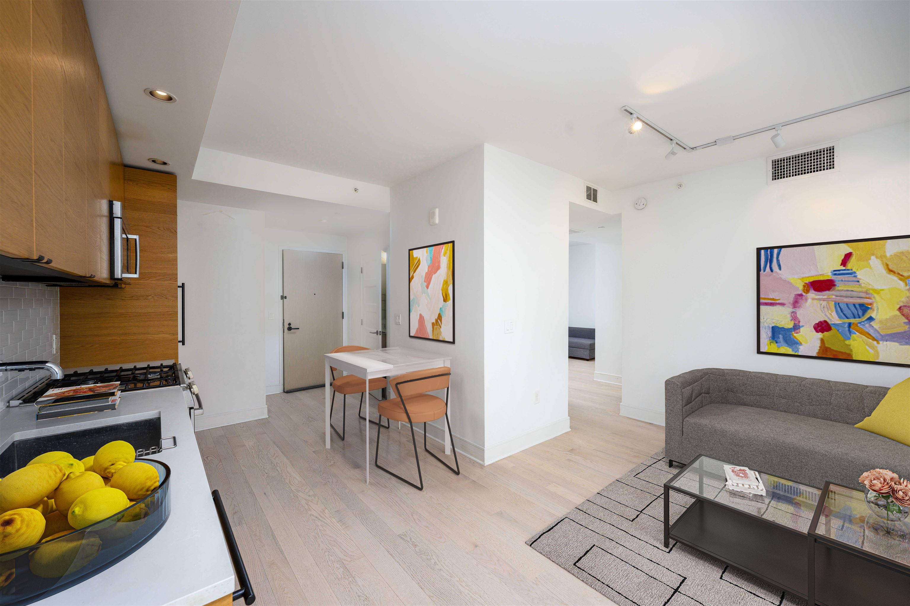 a living room with furniture and wooden floor