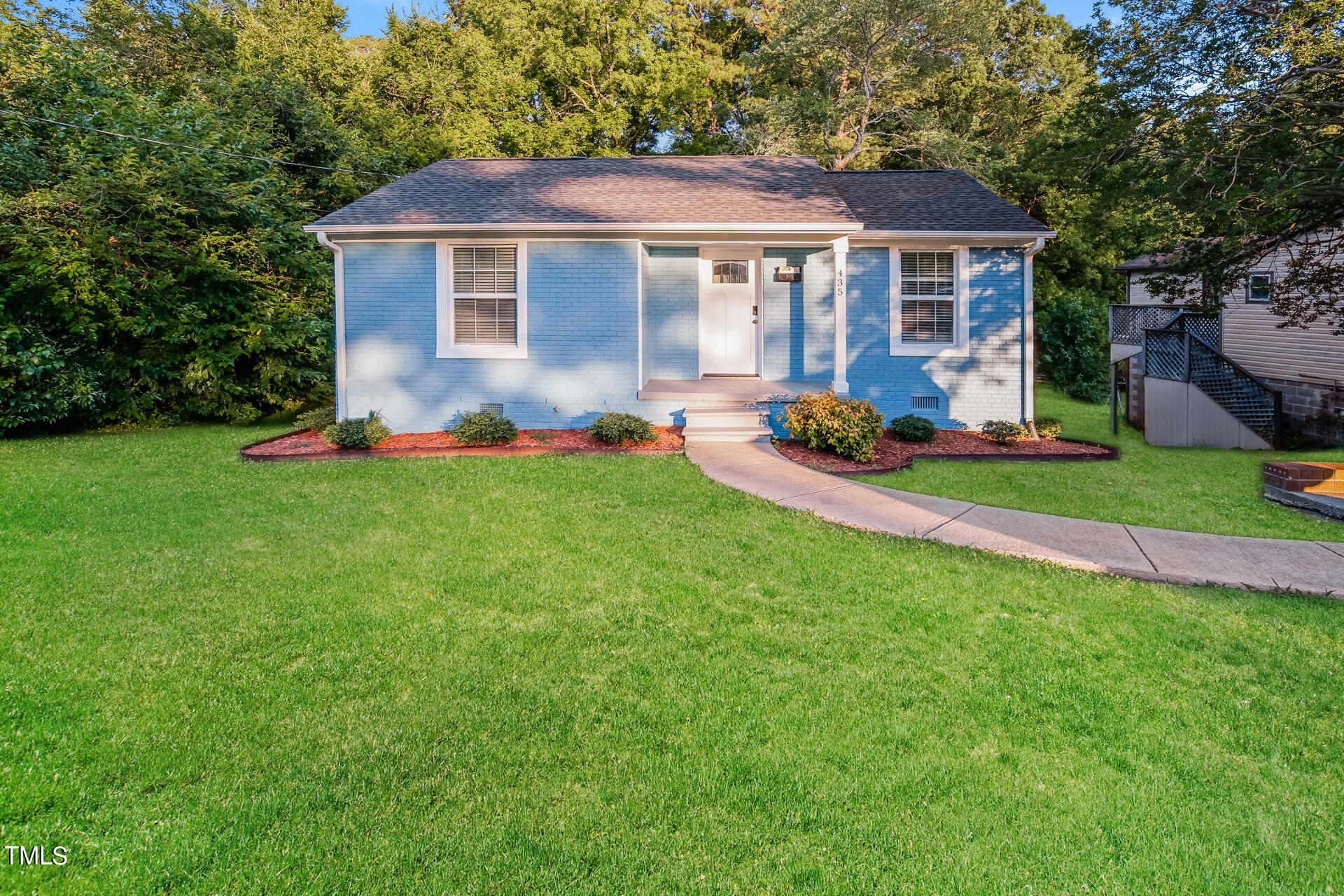 a front view of a house with a yard and porch