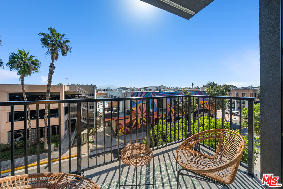 a view of a balcony with wooden floor and outdoor space