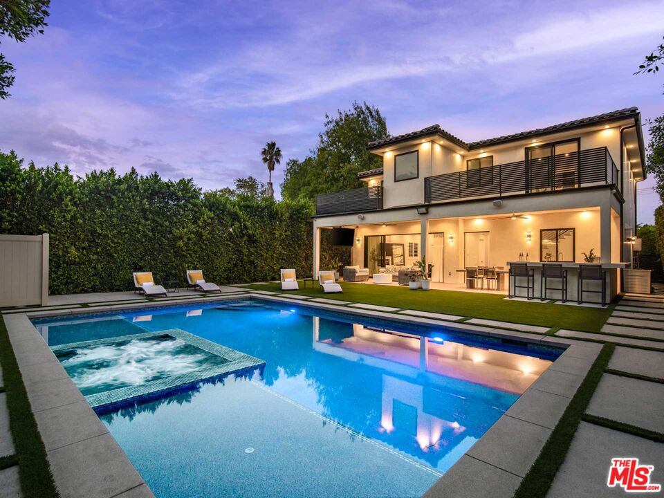 a view of swimming pool with a lounge chairs