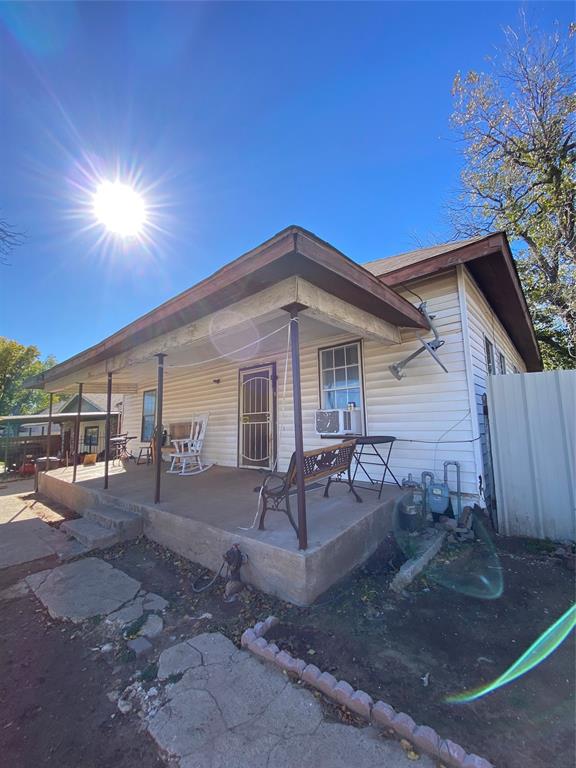 Rear view of property with cooling unit and covered porch