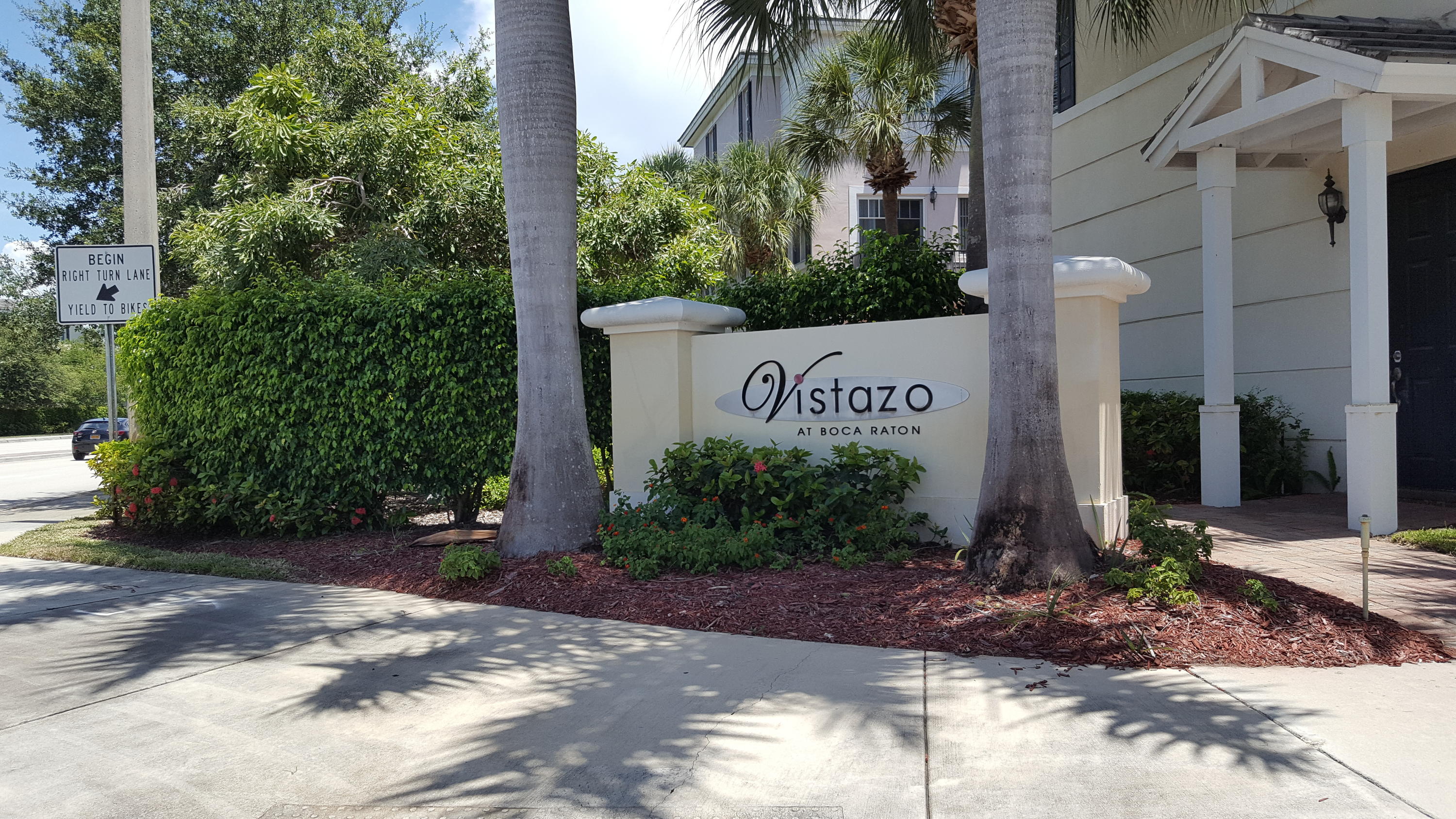 a sign board with buildings in the background