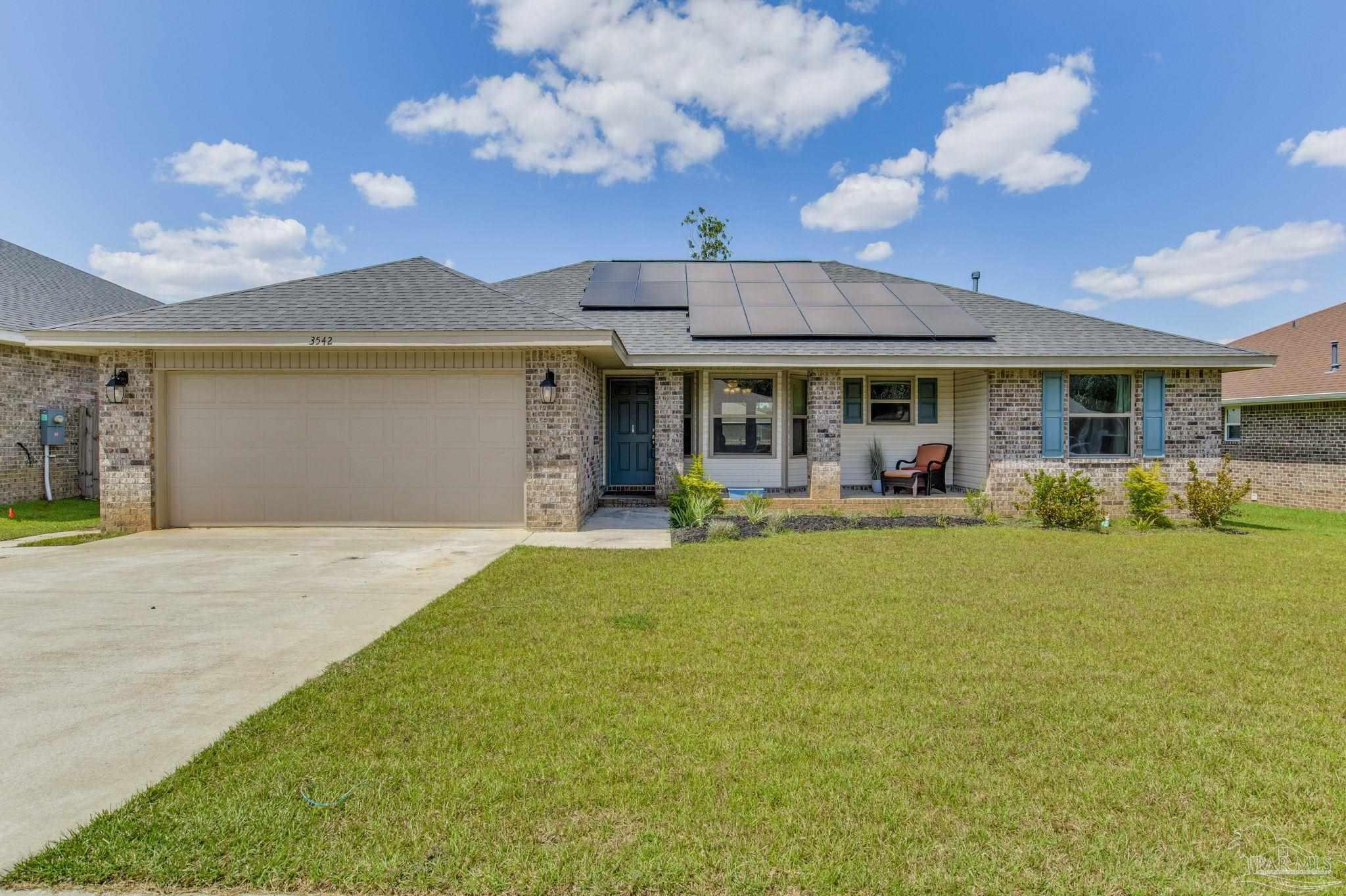 a front view of house with yard and outdoor seating