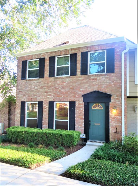 a front view of a house with yard and green space