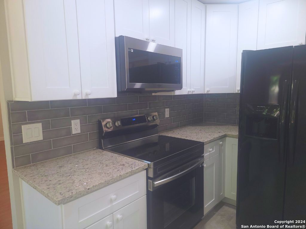 a kitchen with a sink and cabinets