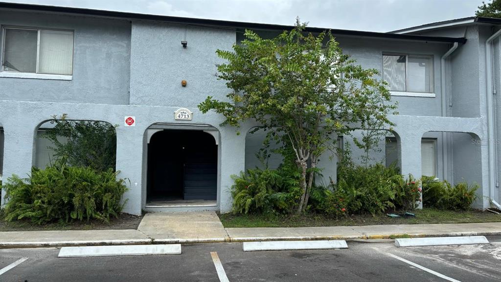 a front view of a house with plants